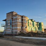 New townhouse under construction with framing and siding in progress