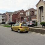 Suburban street of two-storey brick homes in a newer neighbourhood
