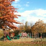 Playground and autumn trees at Centennial Park in Dollard-des-Ormeaux