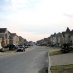 Residential street lined with detached family homes in a Montreal suburb