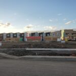 New homes taking shape in a freshly graded subdivision
